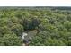 An aerial view showing a home and driveway nestled in the middle of a lush green forest at 4110 Stoneycreek Rd, Chapel Hill, NC 27514