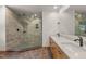 Bright bathroom featuring a glass enclosed shower with natural stone and a double vanity sink at 4110 Stoneycreek Rd, Chapel Hill, NC 27514