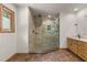 Bright bathroom featuring a glass enclosed shower with natural stone and a wood framed window at 4110 Stoneycreek Rd, Chapel Hill, NC 27514