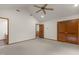 Large bedroom with vaulted ceiling featuring hardwood trim, carpeted floor and a ceiling fan at 4110 Stoneycreek Rd, Chapel Hill, NC 27514