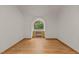 Well lit bedroom featuring hardwood floors, white walls, and an arched window at 4110 Stoneycreek Rd, Chapel Hill, NC 27514