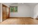 Neutral bedroom with hardwood floors, natural lighting, and a wood closet at 4110 Stoneycreek Rd, Chapel Hill, NC 27514