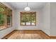 Dining room with hardwood floors and large windows with wooded views at 4110 Stoneycreek Rd, Chapel Hill, NC 27514