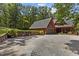 Exterior view of a home featuring garage, wood siding, a well-maintained lawn, and mature trees at 4110 Stoneycreek Rd, Chapel Hill, NC 27514