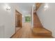 Elegant entryway featuring hardwood floors, staircase, and views of a spacious living area, creating an open feel at 4110 Stoneycreek Rd, Chapel Hill, NC 27514