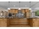 Contemporary kitchen boasting a large island with granite countertops and wooden cabinets, creating a stylish workspace at 4110 Stoneycreek Rd, Chapel Hill, NC 27514