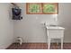 Minimalist laundry room features tiled floor and a large basin sink at 4110 Stoneycreek Rd, Chapel Hill, NC 27514