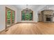 Open living space with hardwood floors, a stone fireplace, and lots of natural light at 4110 Stoneycreek Rd, Chapel Hill, NC 27514