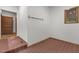 Tiled mudroom with access to the hallway featuring a row of coat hooks and a wooded view at 4110 Stoneycreek Rd, Chapel Hill, NC 27514