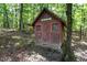 The outbuilding has a red trim, windows, and a sign at 4110 Stoneycreek Rd, Chapel Hill, NC 27514