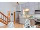 Modern kitchen featuring gray cabinets, stainless steel appliances, and an adjoining dining area, creating a functional space at 524 N Occoneechee St, Hillsborough, NC 27278