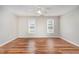 Bright bedroom featuring natural light, neutral walls, ceiling fan, and beautiful wood flooring for a cozy ambiance at 5437 Advantis Dr, Raleigh, NC 27610
