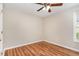 A bright bedroom with a ceiling fan, hardwood floors, and a window at 5437 Advantis Dr, Raleigh, NC 27610