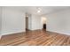 Spacious bedroom with wood floors, neutral paint, ceiling fan, and adjacent bathroom access for added convenience at 5437 Advantis Dr, Raleigh, NC 27610