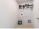 The laundry room is equipped with overhead wire shelving and has a tile floor at 55 Fern Ridge Dr, Cameron, NC 28326