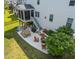 Aerial view of a backyard featuring a stone patio with an outdoor kitchen and fire pit at 633 Copper Beech Ln, Wake Forest, NC 27587