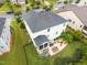Aerial view of a white home with a patio, outdoor kitchen, and a fire pit in the backyard at 633 Copper Beech Ln, Wake Forest, NC 27587