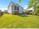 Expansive backyard with lush lawn, patio, and covered outdoor kitchen at 633 Copper Beech Ln, Wake Forest, NC 27587
