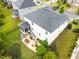 Aerial view of a backyard featuring outdoor seating, a screened porch, a dining area, and a manicured lawn at 633 Copper Beech Ln, Wake Forest, NC 27587