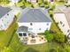 Aerial view of a backyard featuring outdoor seating, a screened porch, a dining area, and a manicured lawn at 633 Copper Beech Ln, Wake Forest, NC 27587
