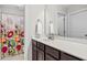 Bright bathroom featuring a vanity with a sink and a shower with a floral curtain at 633 Copper Beech Ln, Wake Forest, NC 27587