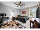 Modern bedroom with dark-toned bedding, a desk, and a view of the outdoors at 633 Copper Beech Ln, Wake Forest, NC 27587