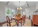 Formal dining room featuring a coffered ceiling, wainscoting, and a wood table at 633 Copper Beech Ln, Wake Forest, NC 27587