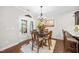 Bright dining room features hardwood floors, neutral walls, and door to backyard at 633 Copper Beech Ln, Wake Forest, NC 27587