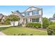 Charming two-story home features a well-manicured lawn and a blooming tree, creating a welcoming curb appeal at 633 Copper Beech Ln, Wake Forest, NC 27587