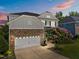 Charming two-story home with a stone-accented garage, landscaped front yard, and a colorful tree in bloom at 633 Copper Beech Ln, Wake Forest, NC 27587