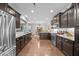 Spacious kitchen with dark cabinets, granite countertops, and stainless steel appliances, perfect for cooking at 633 Copper Beech Ln, Wake Forest, NC 27587