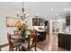 Cozy breakfast nook with a round table, pendant lighting, and a view of the modern kitchen with granite countertops at 633 Copper Beech Ln, Wake Forest, NC 27587