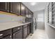 Well-equipped laundry room with ample counter space, storage cabinets, and modern washer/dryer at 633 Copper Beech Ln, Wake Forest, NC 27587