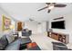 Bright living room with ceiling fan and dark wood entertainment center at 633 Copper Beech Ln, Wake Forest, NC 27587