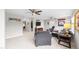 Bright living room with gray chair, carpeting, and sporty decor at 633 Copper Beech Ln, Wake Forest, NC 27587