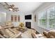 Cozy living room featuring hardwood floors, fireplace, ceiling fan, and neutral paint at 633 Copper Beech Ln, Wake Forest, NC 27587
