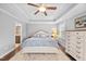 Main bedroom featuring tray ceiling, ceiling fan, large bed, and neutral color palette at 633 Copper Beech Ln, Wake Forest, NC 27587
