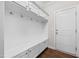 Mudroom area includes white cabinets and a built in bench next to the entry door at 633 Copper Beech Ln, Wake Forest, NC 27587