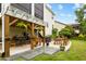 Covered patio featuring a wooden pergola, hanging plants, an outdoor kitchen, and an outdoor dining set at 633 Copper Beech Ln, Wake Forest, NC 27587