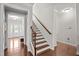 View of staircase features wood steps and banister, and an entry to main hallway at 633 Copper Beech Ln, Wake Forest, NC 27587