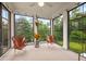Sunroom with multiple black-framed windows and casual seating at 633 Copper Beech Ln, Wake Forest, NC 27587