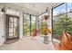 Bright sunroom with expansive views and modern furnishings at 633 Copper Beech Ln, Wake Forest, NC 27587