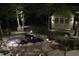 Night view of the illuminated pond and charming wooden house, creating a magical outdoor space at 648 Long Melford Dr, Rolesville, NC 27571