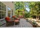 Serene backyard with a brick patio, pergola seating area, and lush greenery for a peaceful outdoor escape at 648 Long Melford Dr, Rolesville, NC 27571