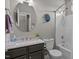 Bright bathroom featuring a round mirror, single vanity, tub, and shower combo at 648 Long Melford Dr, Rolesville, NC 27571