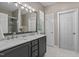 Bathroom with dual sinks, marble countertop, large mirror, and access to walk-in closet at 648 Long Melford Dr, Rolesville, NC 27571