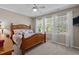 Serene bedroom featuring a wooden bed frame, plush bedding, and soft, natural light at 648 Long Melford Dr, Rolesville, NC 27571