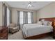 Comfortable bedroom with a large bed, an upholstered chair, and soft window lighting at 648 Long Melford Dr, Rolesville, NC 27571