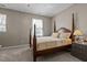 Comfortable bedroom featuring a four-poster bed, soft carpet, and natural light at 648 Long Melford Dr, Rolesville, NC 27571