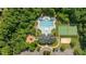 A high angle of the community pool area, showcasing the pool, tennis courts, and playground at 648 Long Melford Dr, Rolesville, NC 27571